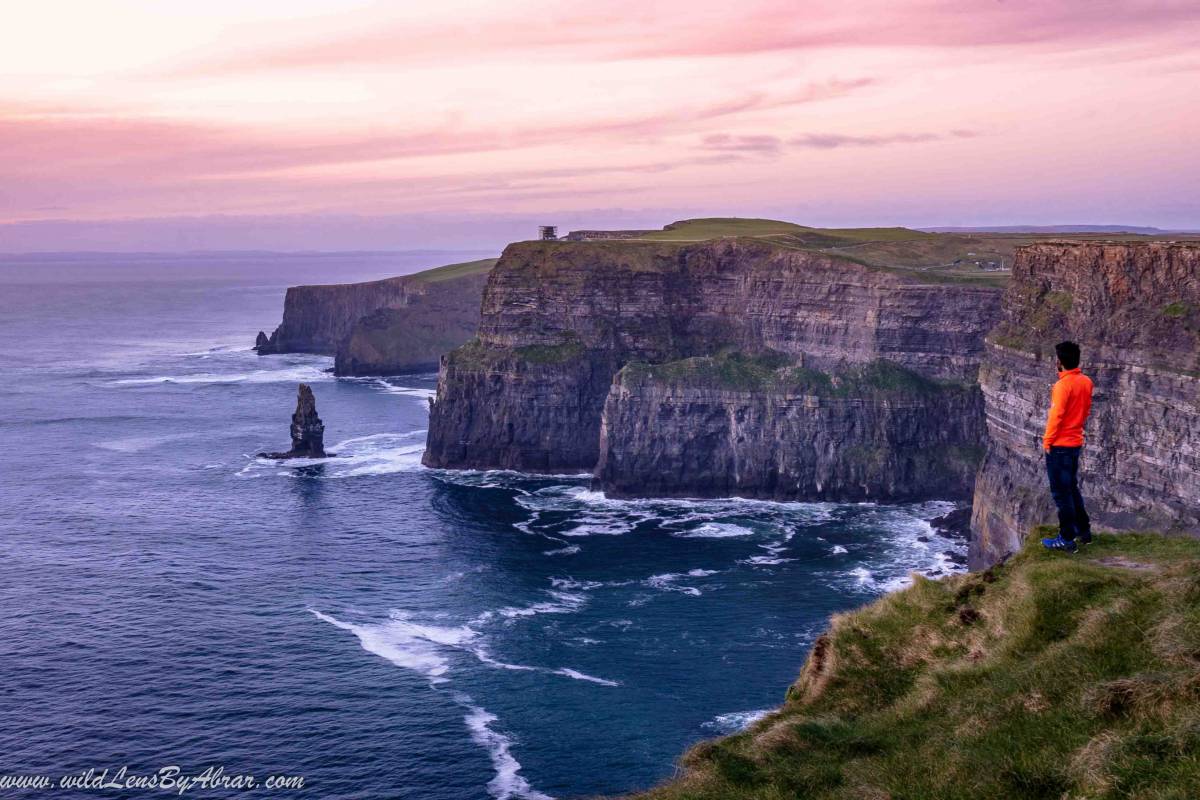 Admiring the views at sunset on Cliffs of Moher