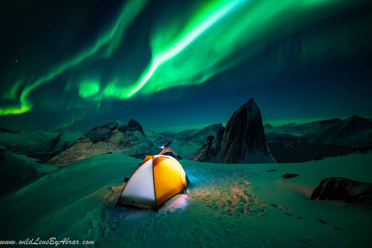 Camping on Hesten mountain in winter overlooking Segla mountain on Senja Island