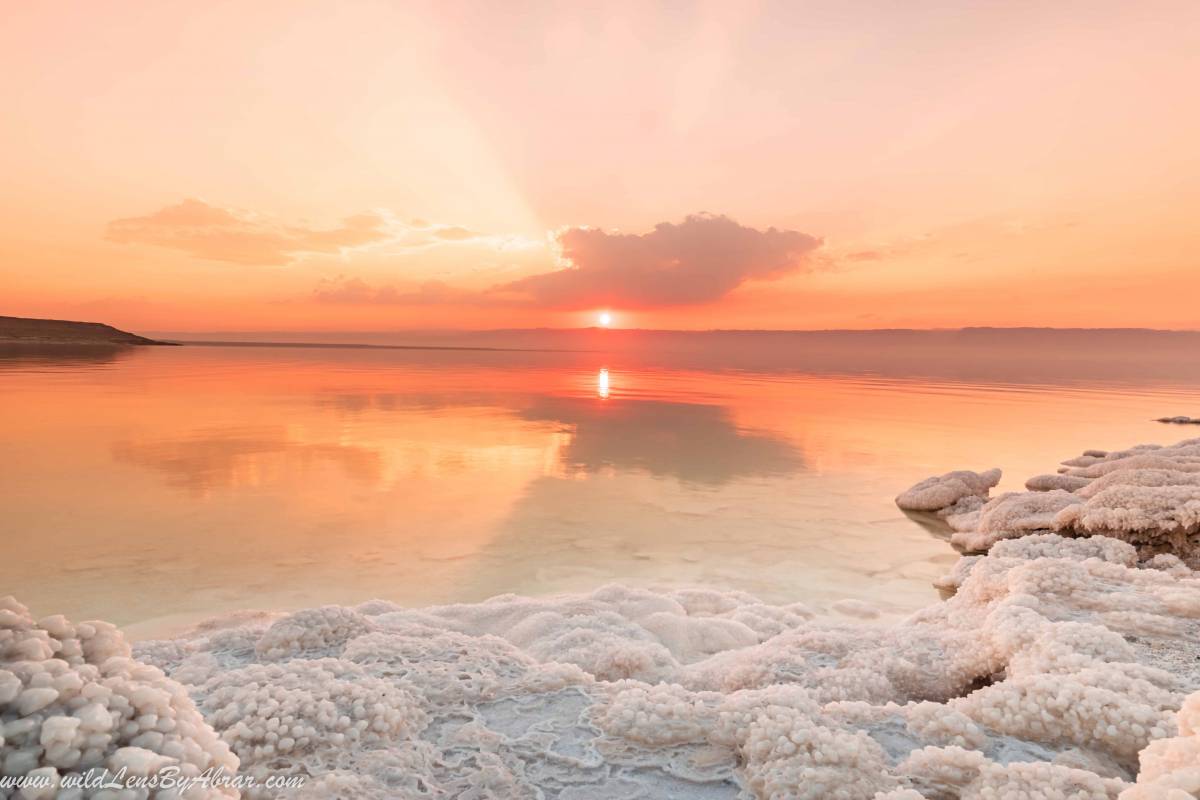 Sun was disappearing behind the mountains on the other side of dead sea in Israel