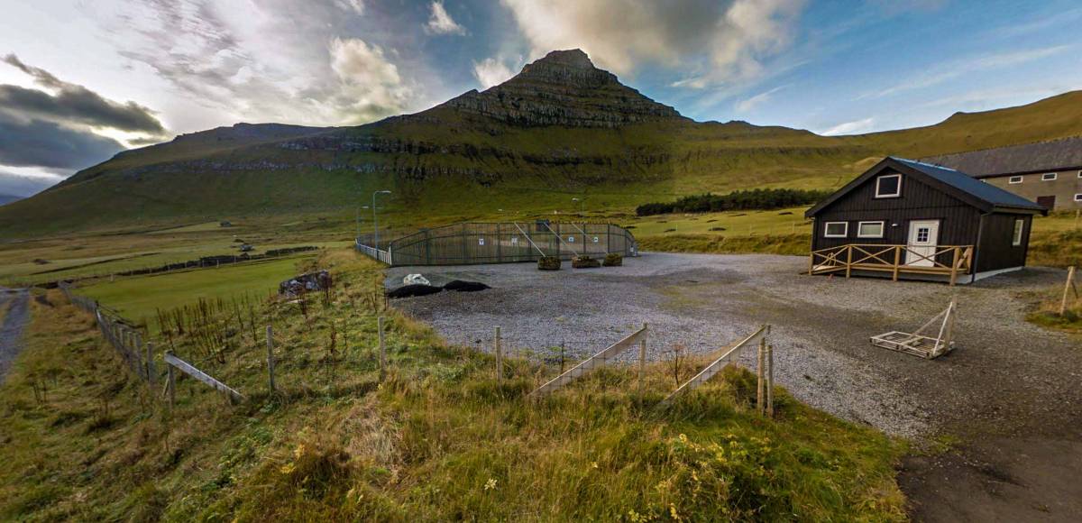 Kalsoy Campsite: on the left side the green area is the campsite and on the right is the rental hut