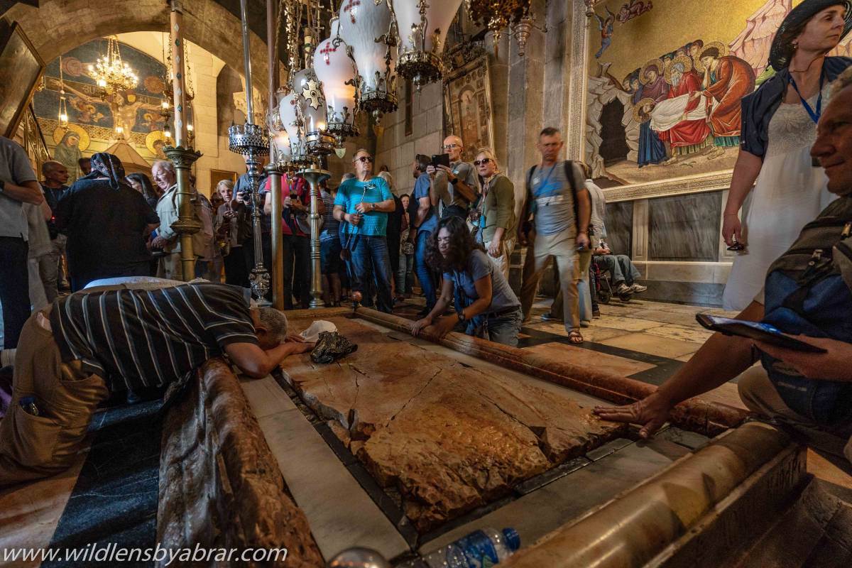 Visitors praying inside the Church of Holy Sepulchre